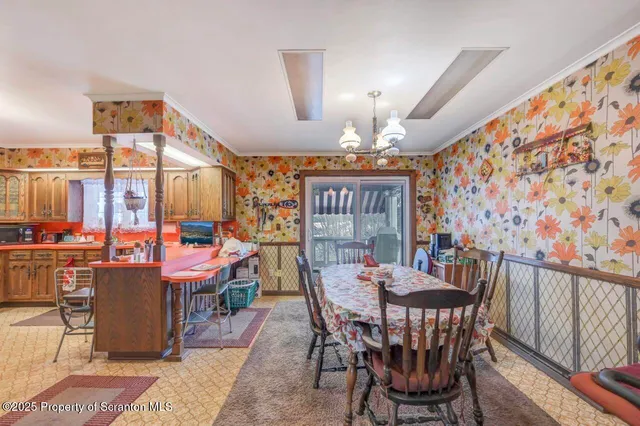 a view of a dining room with furniture and chandelier