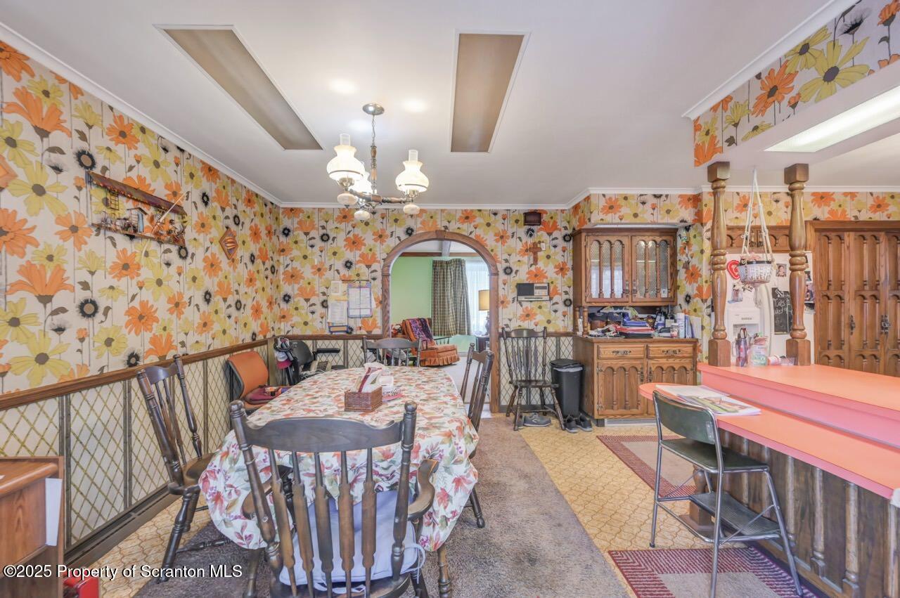 828 Glenwood Road Old Forge, PA 18518 - Photo 18 of 97 a view of a dining room with furniture one side kitchen view and wooden floor