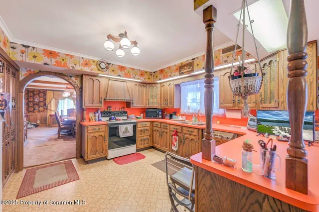 a view of a dining room with furniture and chandelier