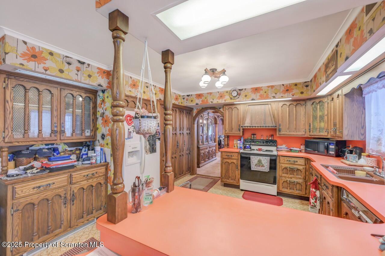828 Glenwood Road Old Forge, PA 18518 - Photo 21 of 97 a kitchen with stainless steel appliances a stove a sink dishwasher and cabinets with wooden floor