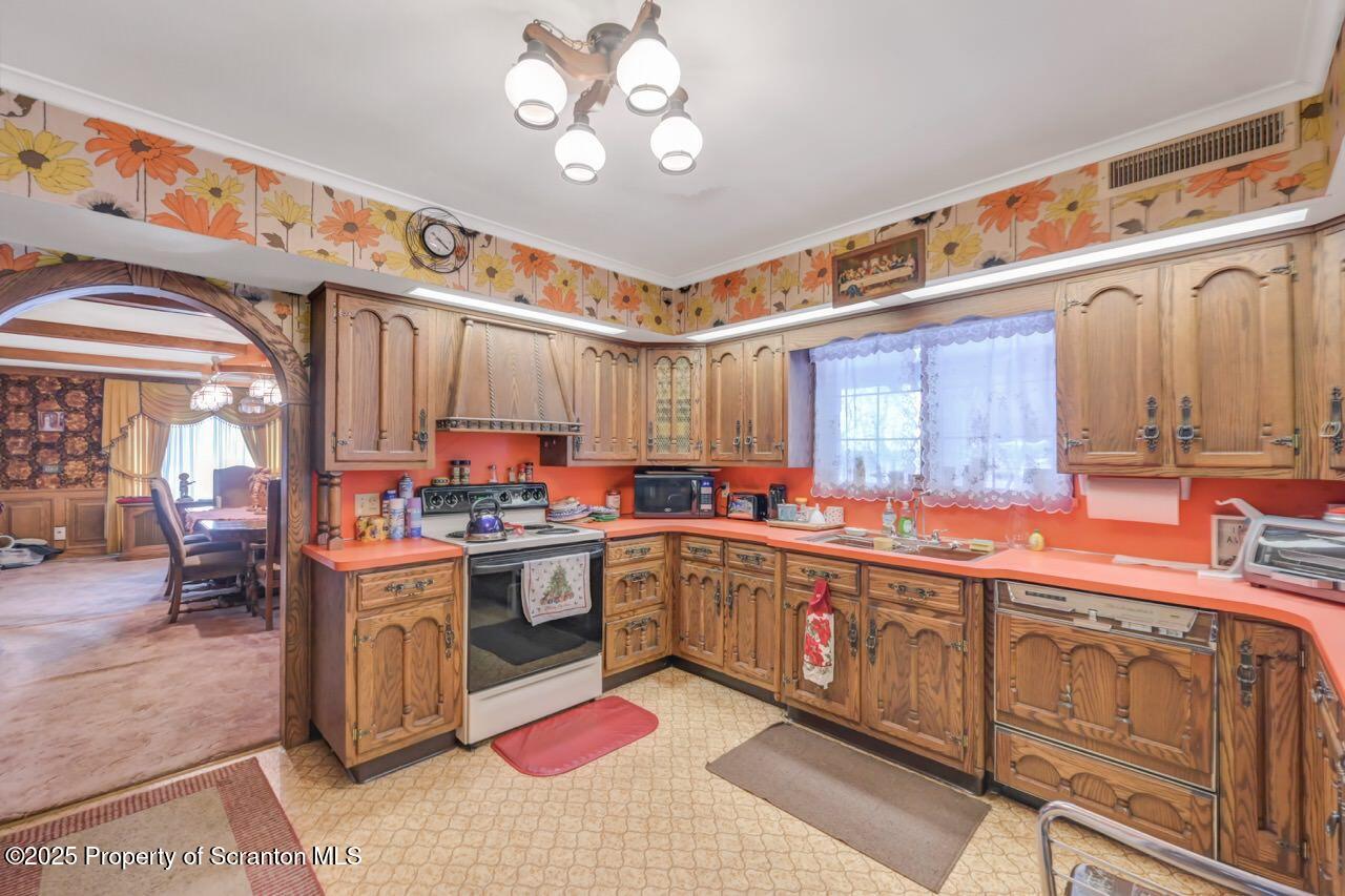 828 Glenwood Road Old Forge, PA 18518 - Photo 22 of 97 a kitchen with stainless steel appliances granite countertop a sink and cabinets