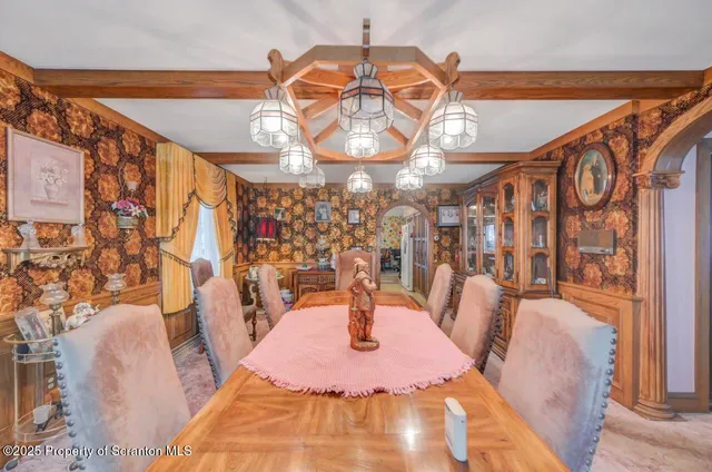 a spacious bedroom with two bed and a chandelier