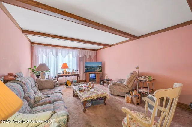 a spacious bedroom with a bed and a chandelier