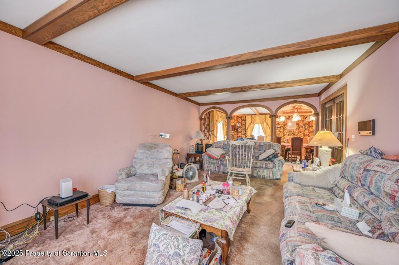 828 Glenwood Road Old Forge, PA 18518 - Photo 36 of 97 a living room with furniture and a floor to ceiling window