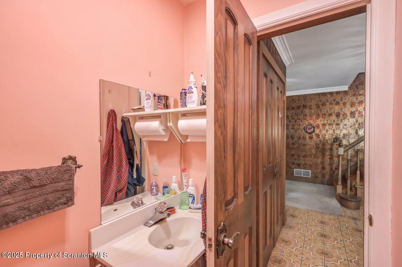 828 Glenwood Road Old Forge, PA 18518 - Photo 38 of 97 a bathroom with a sink and a mirror