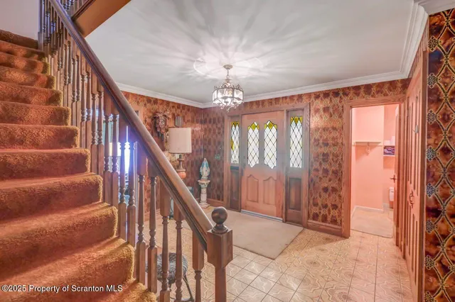 a view of a hallway with wooden floor and furniture