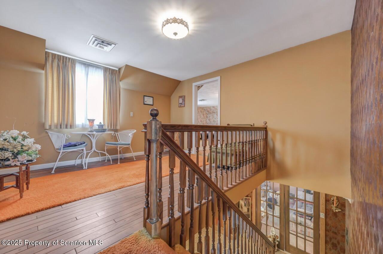 828 Glenwood Road Old Forge, PA 18518 - Photo 41 of 97 a view of a hallway with dining room and wooden floor