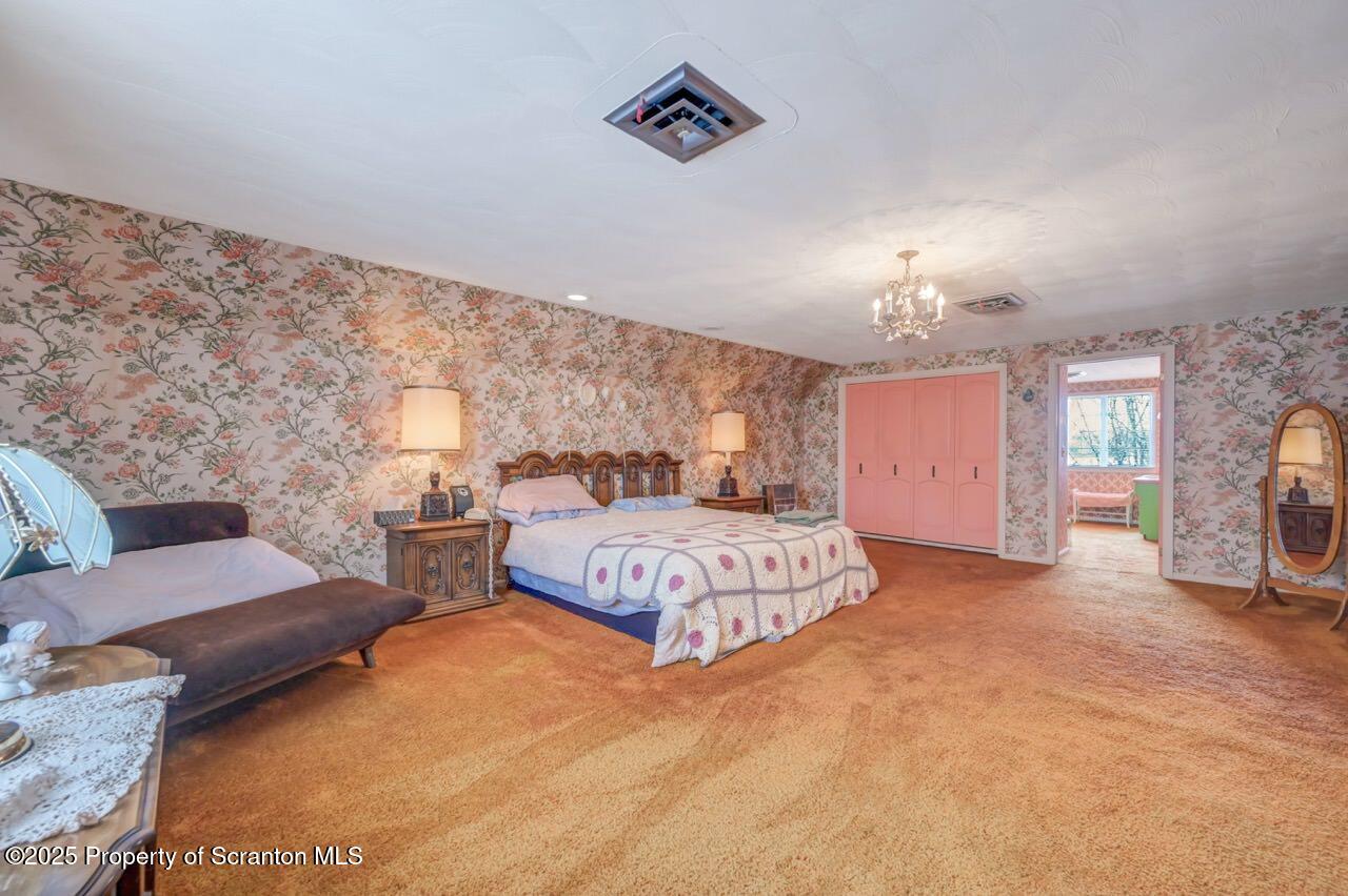 828 Glenwood Road Old Forge, PA 18518 - Photo 42 of 97 a spacious bedroom with a bed window and couch