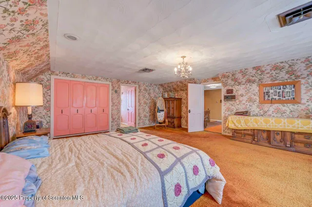 a dining room with furniture and a chandelier
