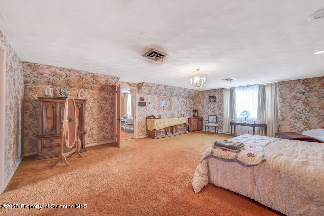 828 Glenwood Road Old Forge, PA 18518 - Photo 45 of 97 a spacious bedroom with a bed and ceiling fan