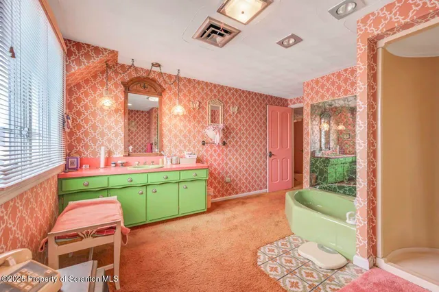 a bathroom with a toilet a sink and shower curtain