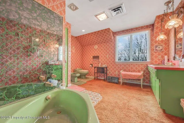 a bathroom with double vanity and a bathtub