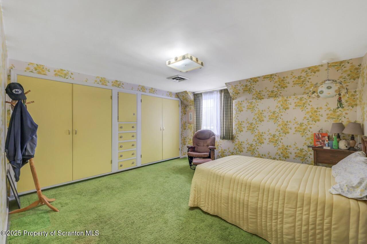 828 Glenwood Road Old Forge, PA 18518 - Photo 53 of 97 a bedroom with a bed closet and a window