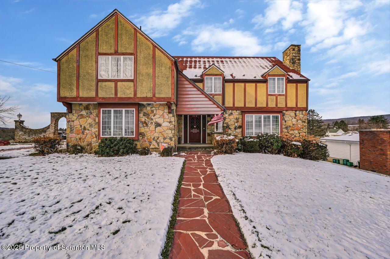828 Glenwood Road Old Forge, PA 18518 - Photo 6 of 97 a view of a brick house with many windows
