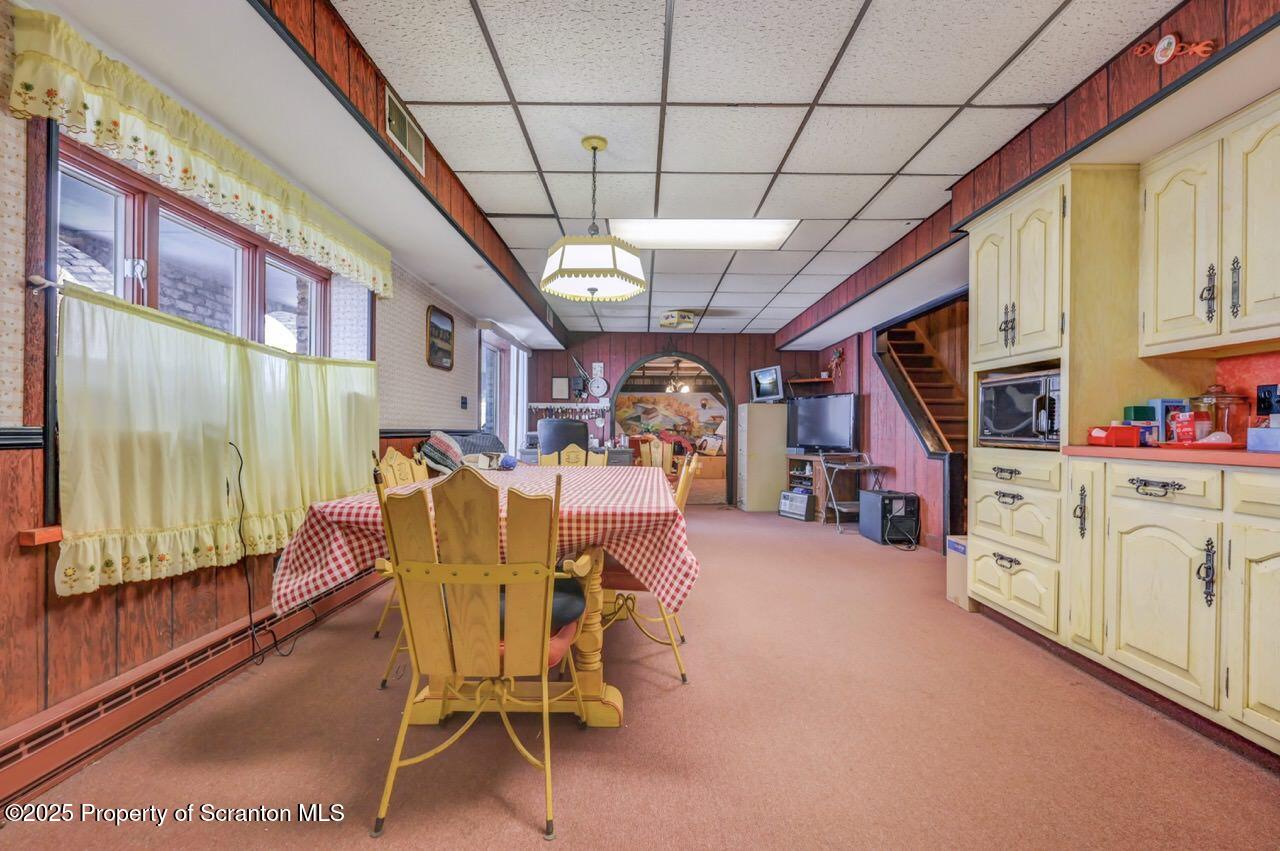 828 Glenwood Road Old Forge, PA 18518 - Photo 64 of 97 a dining room with furniture and a chandelier