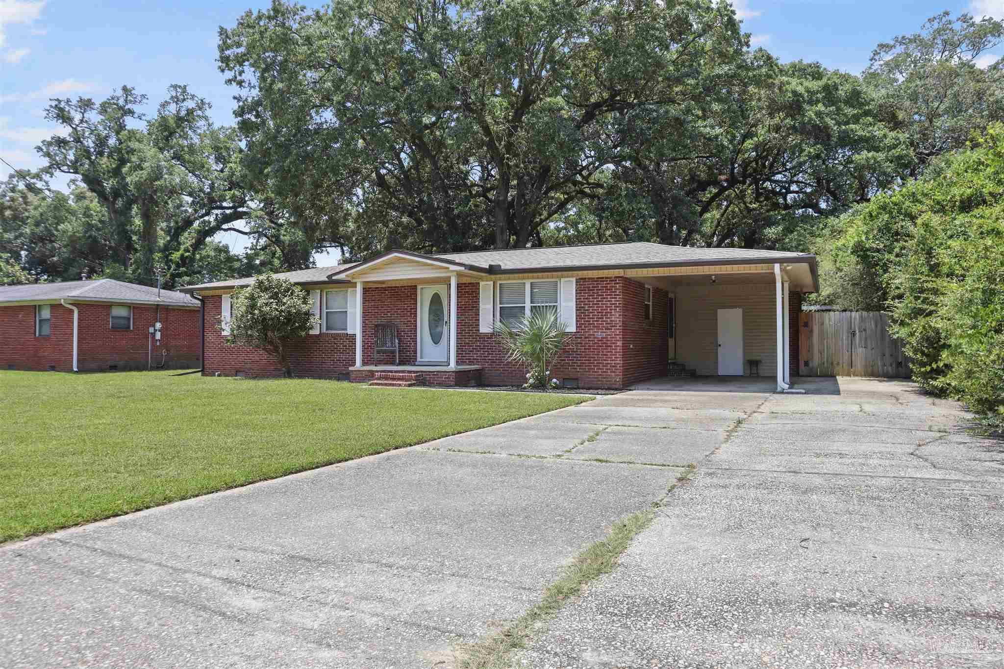 5925 Prince Road Pensacola, FL 32503 - Photo 1 of 51 a front view of house with yard and outdoor seating