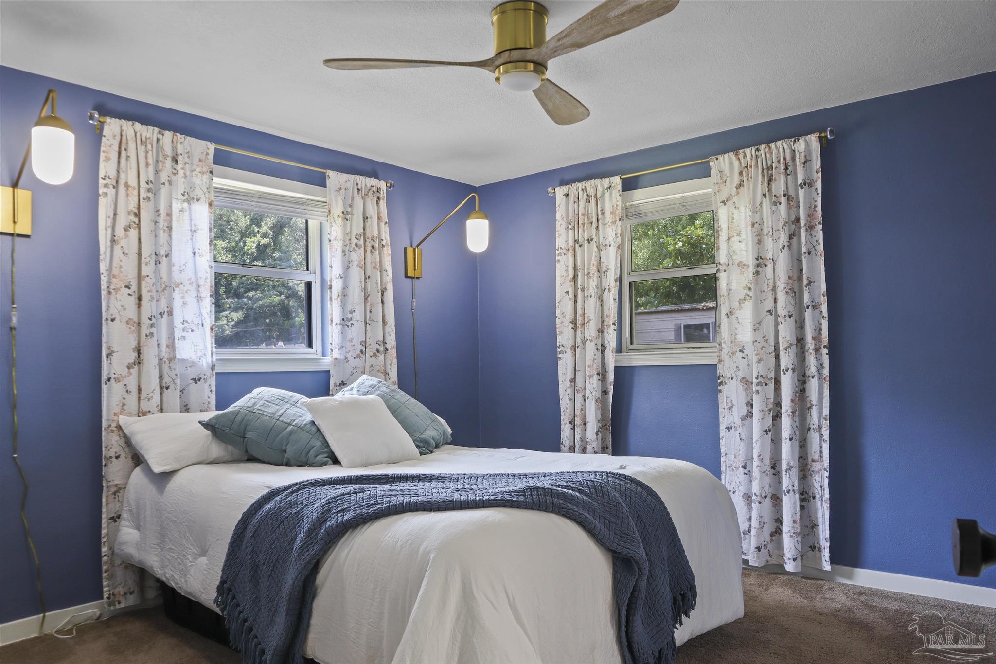 5925 Prince Road Pensacola, FL 32503 - Photo 15 of 51 a bedroom with a large bed and a large window