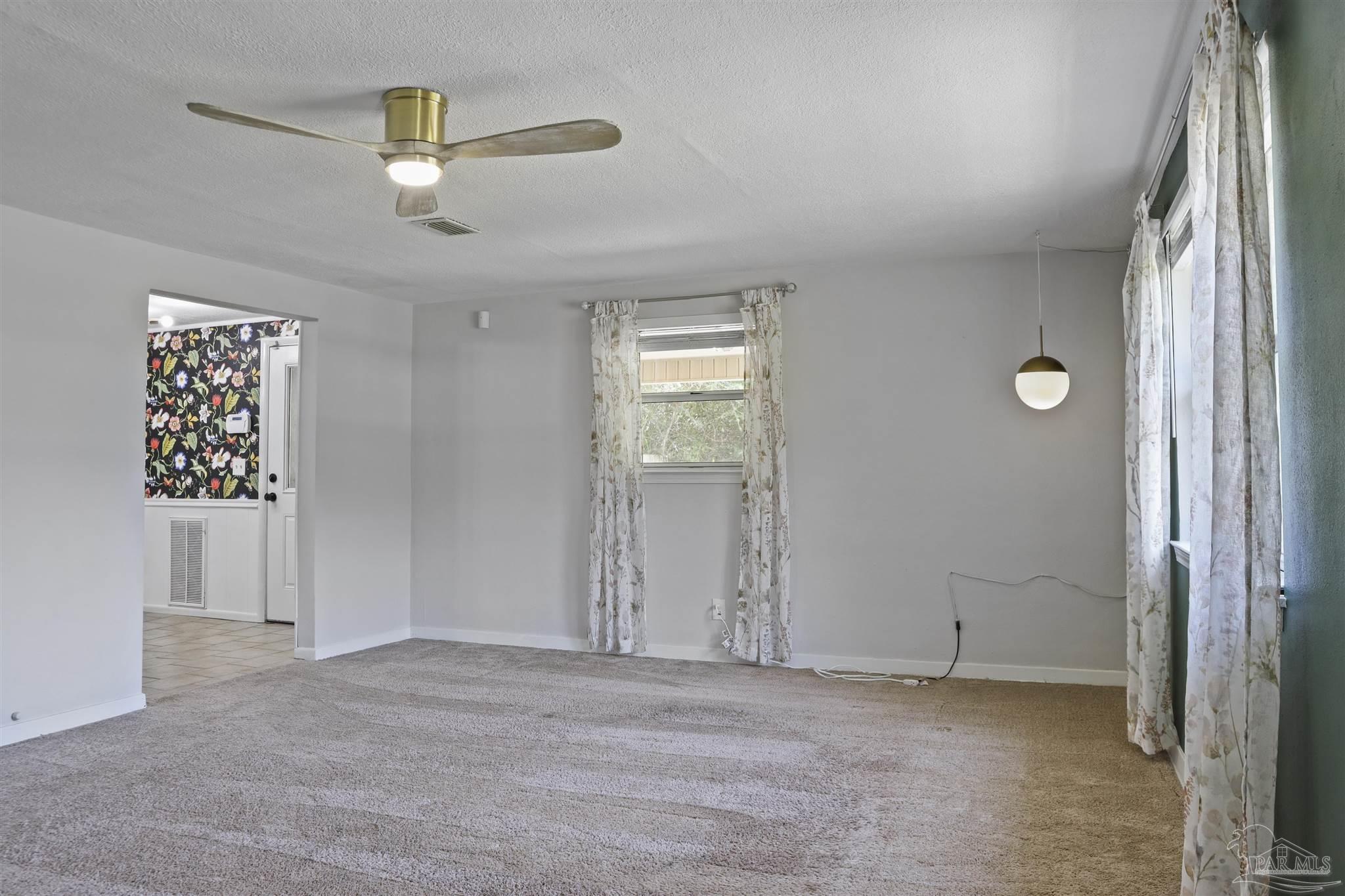 5925 Prince Road Pensacola, FL 32503 - Photo 2 of 51 an empty room with windows and fan