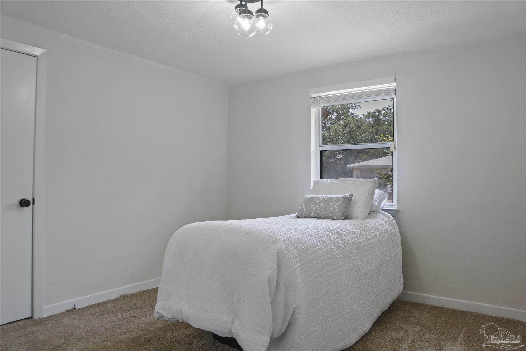 5925 Prince Road Pensacola, FL 32503 - Photo 25 of 51 a bedroom with a bed and a window