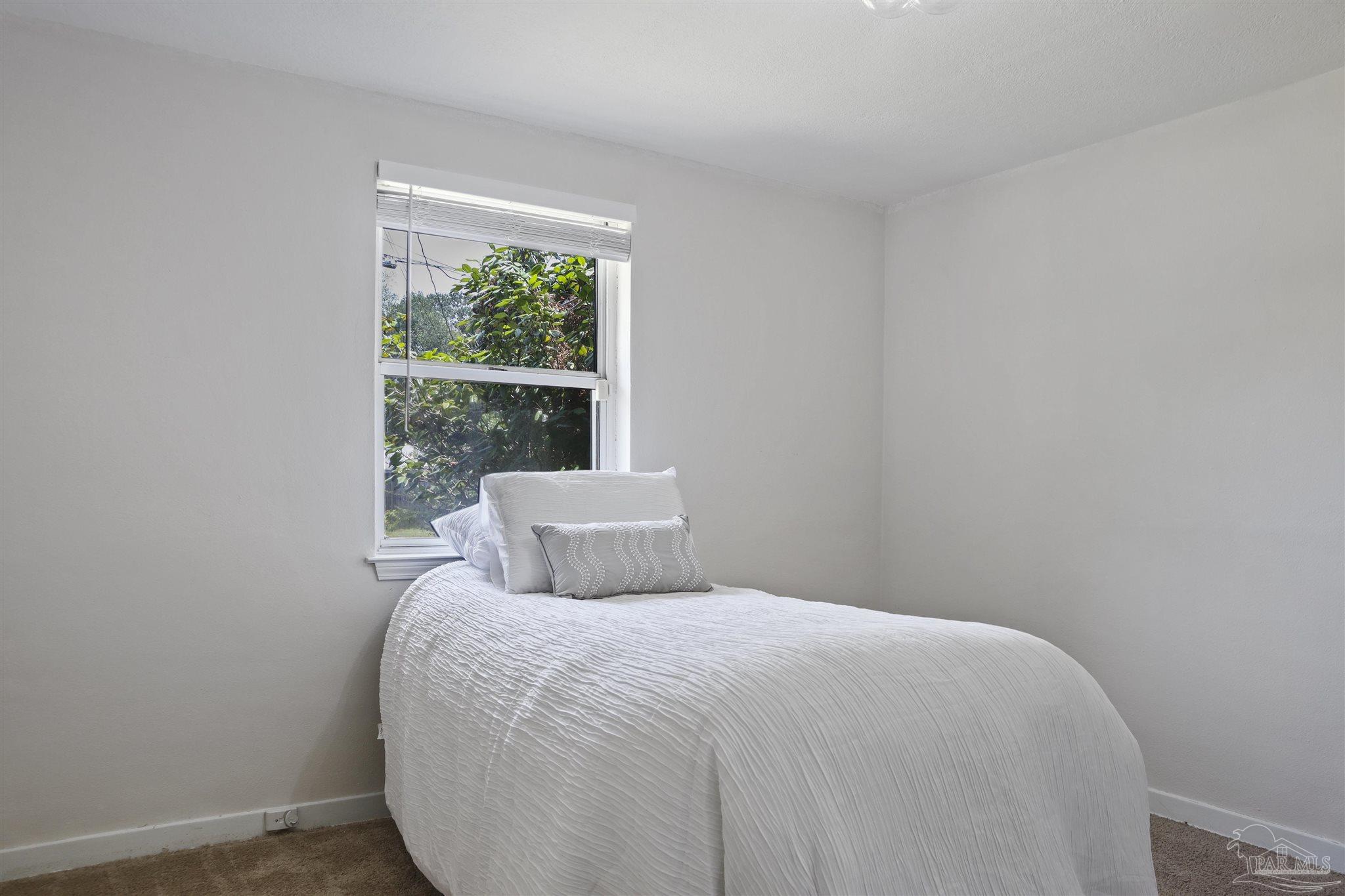 5925 Prince Road Pensacola, FL 32503 - Photo 27 of 51 a bedroom with a bed and a window