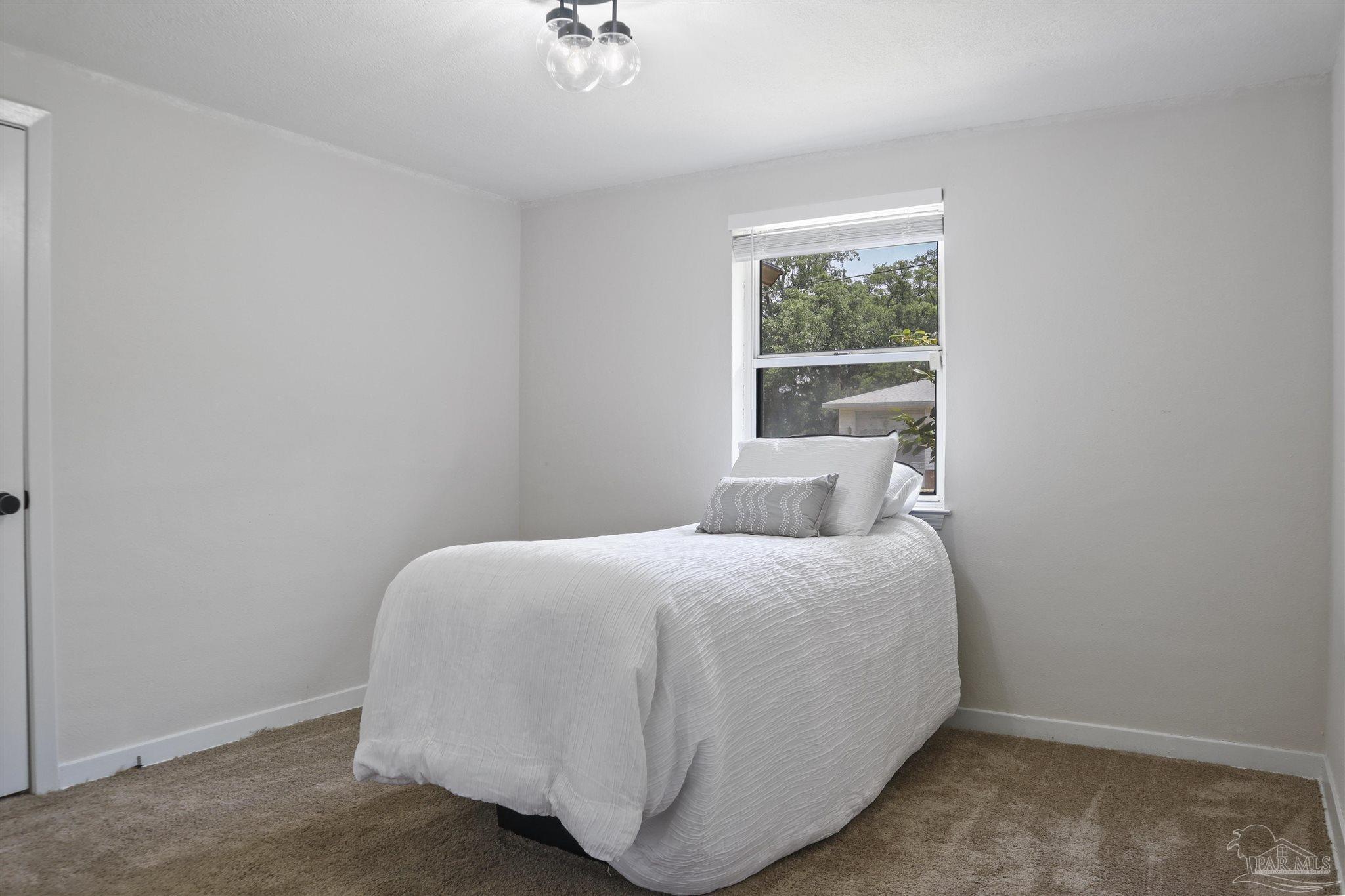 5925 Prince Road Pensacola, FL 32503 - Photo 29 of 51 a bedroom with a bed and window