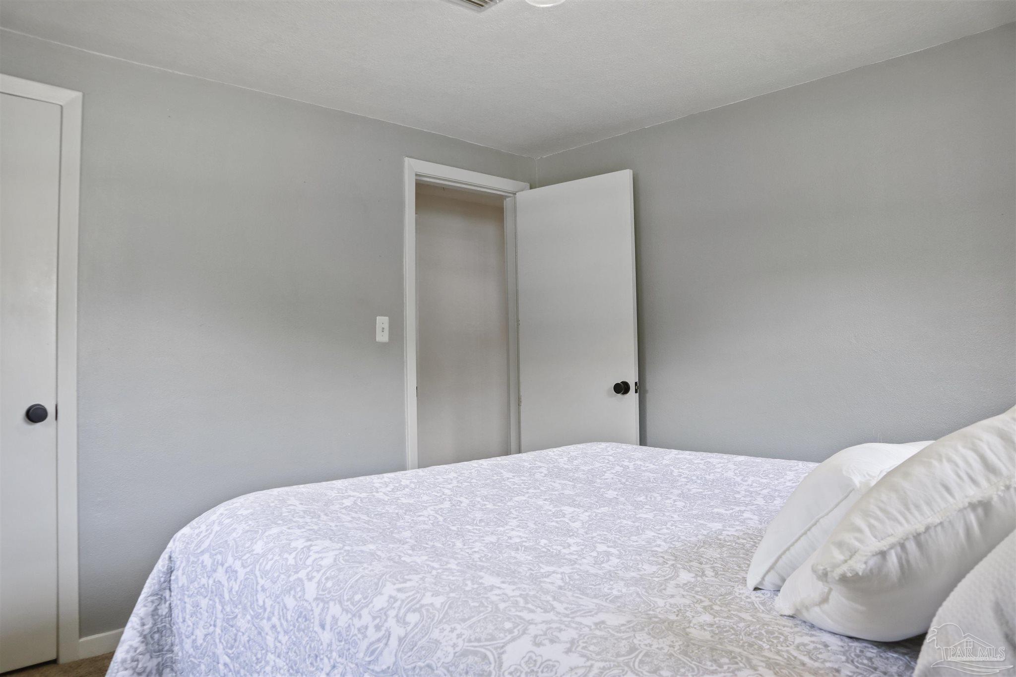 5925 Prince Road Pensacola, FL 32503 - Photo 30 of 51 a bedroom with a bed and a mirror