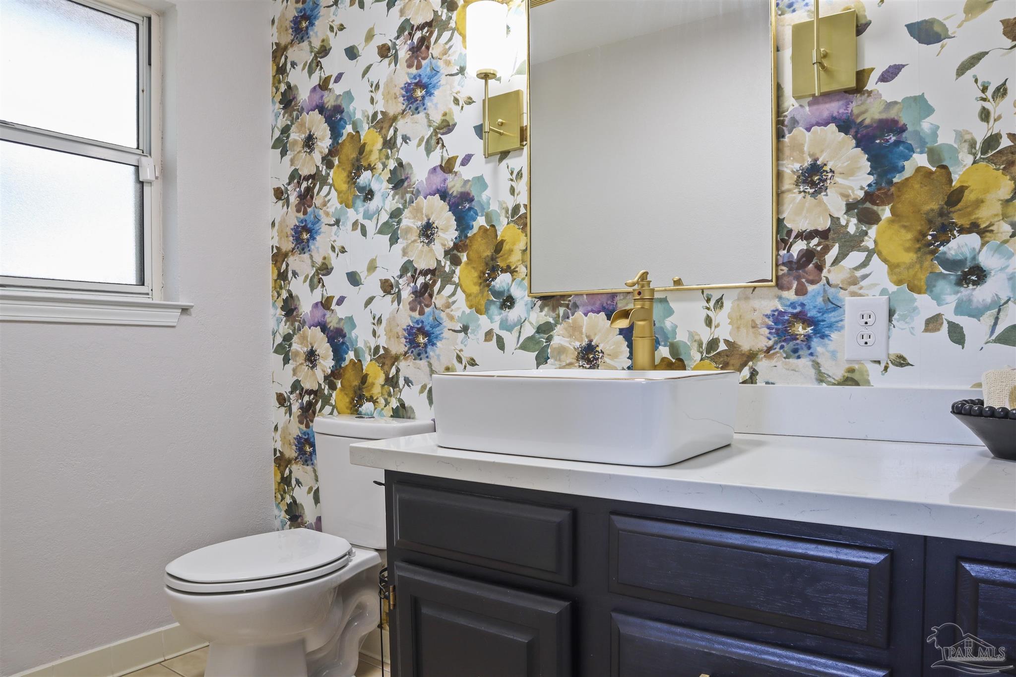 5925 Prince Road Pensacola, FL 32503 - Photo 32 of 51 a bathroom with a sink toilet and a mirror