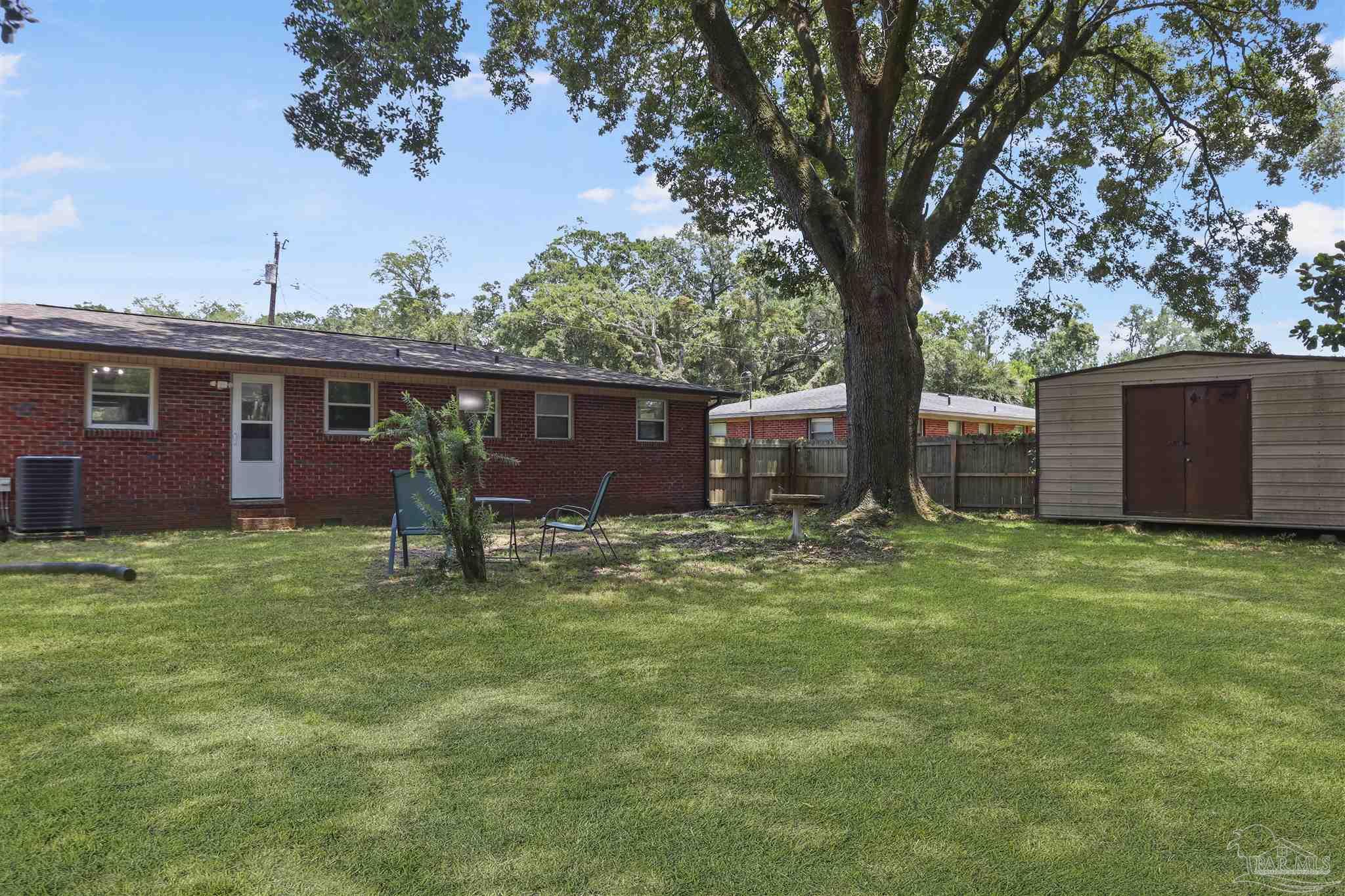 5925 Prince Road Pensacola, FL 32503 - Photo 37 of 51 a backyard of a house with lots of green space