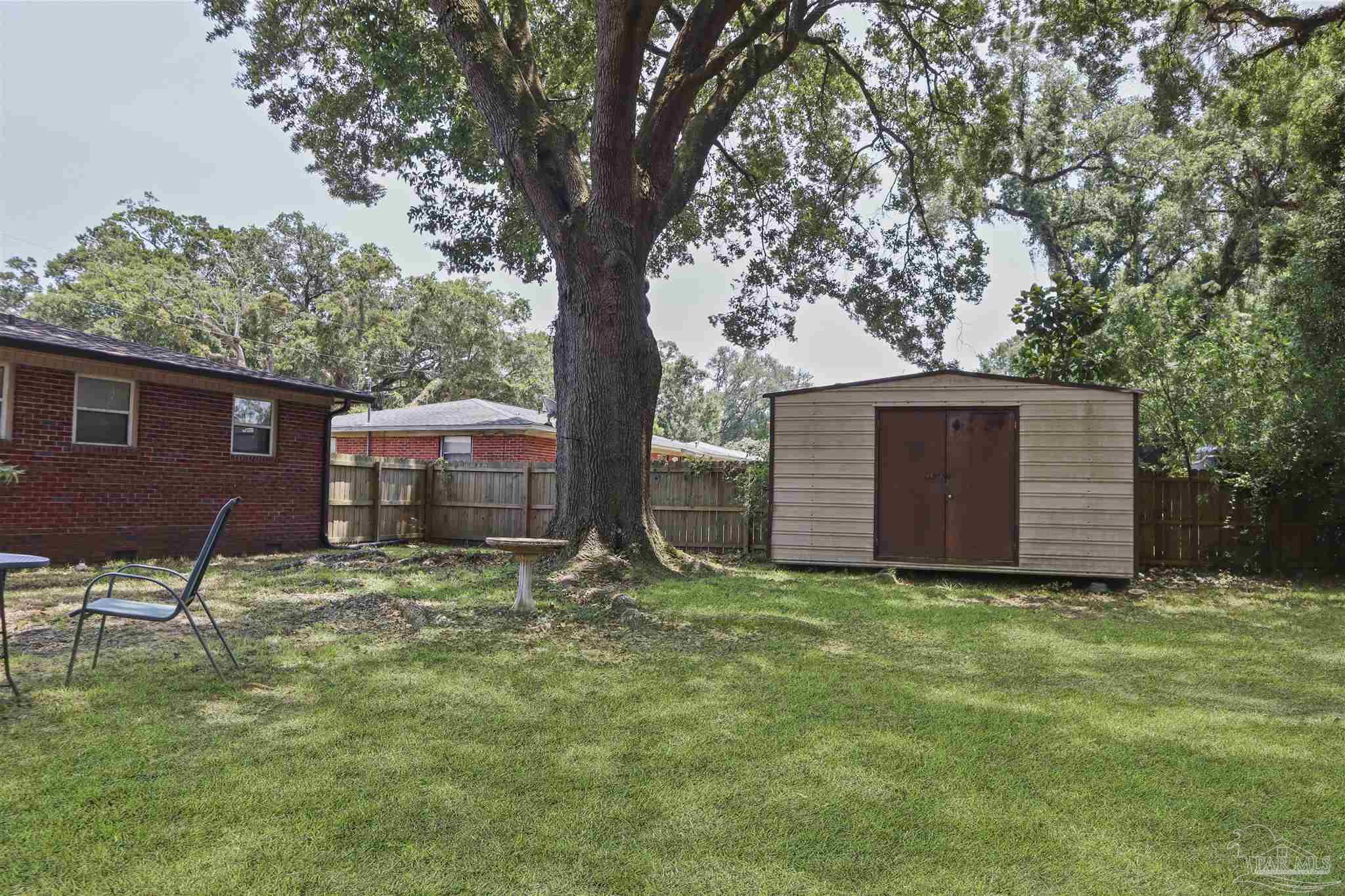 5925 Prince Road Pensacola, FL 32503 - Photo 39 of 51 a view of a backyard with large trees