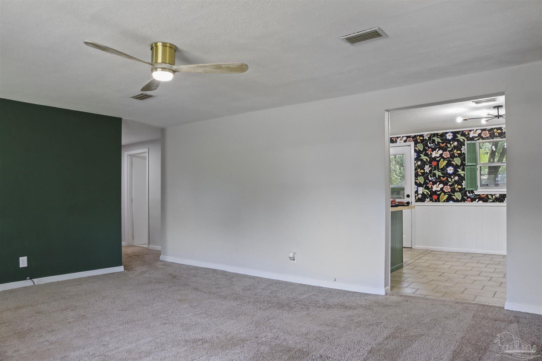 5925 Prince Road Pensacola, FL 32503 - Photo 4 of 51 en empty room with window and ceiling fan