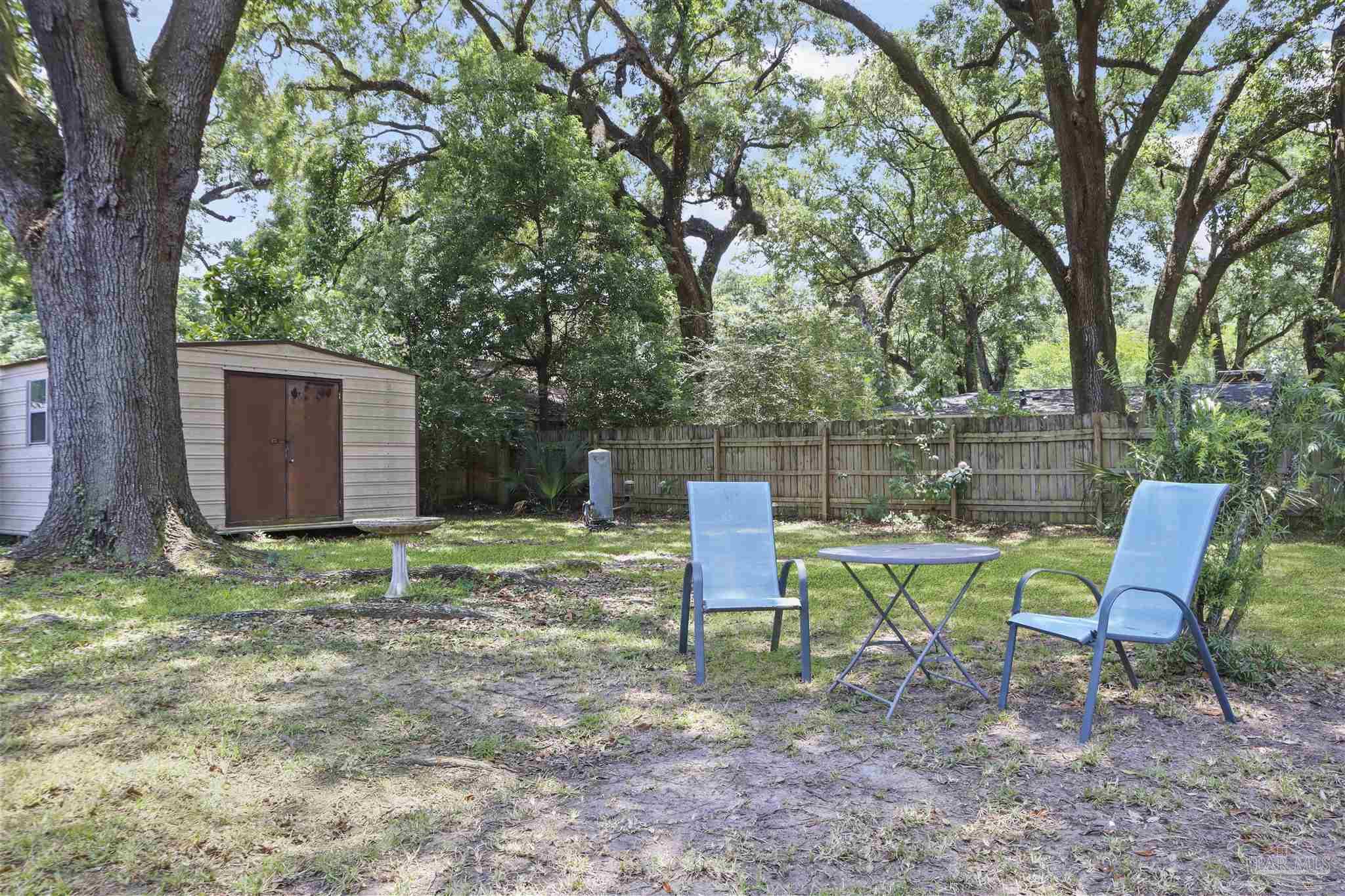 5925 Prince Road Pensacola, FL 32503 - Photo 41 of 51 a backyard of a house with table and chairs