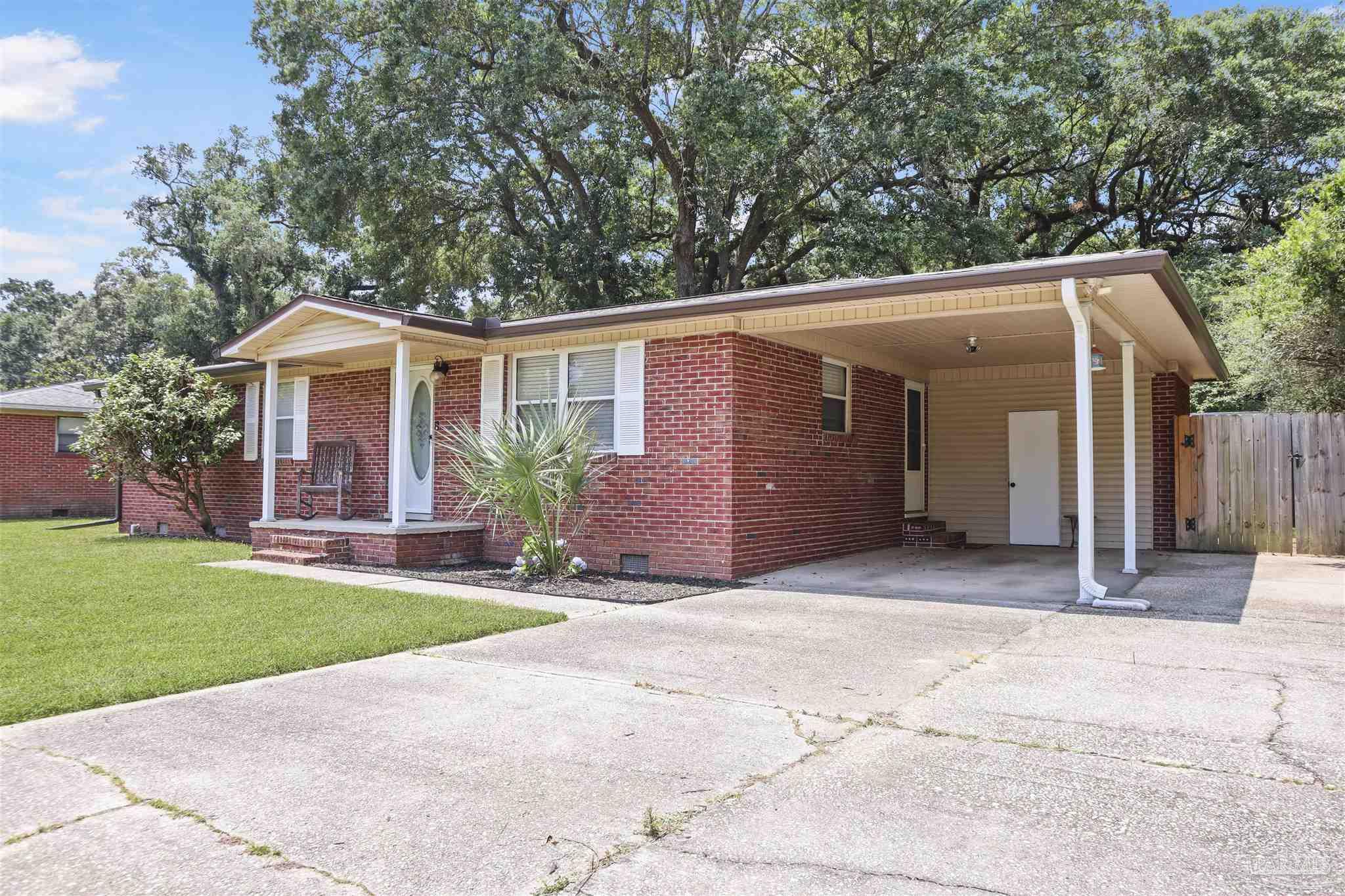 5925 Prince Road Pensacola, FL 32503 - Photo 43 of 51 a front view of a house with a yard and garage