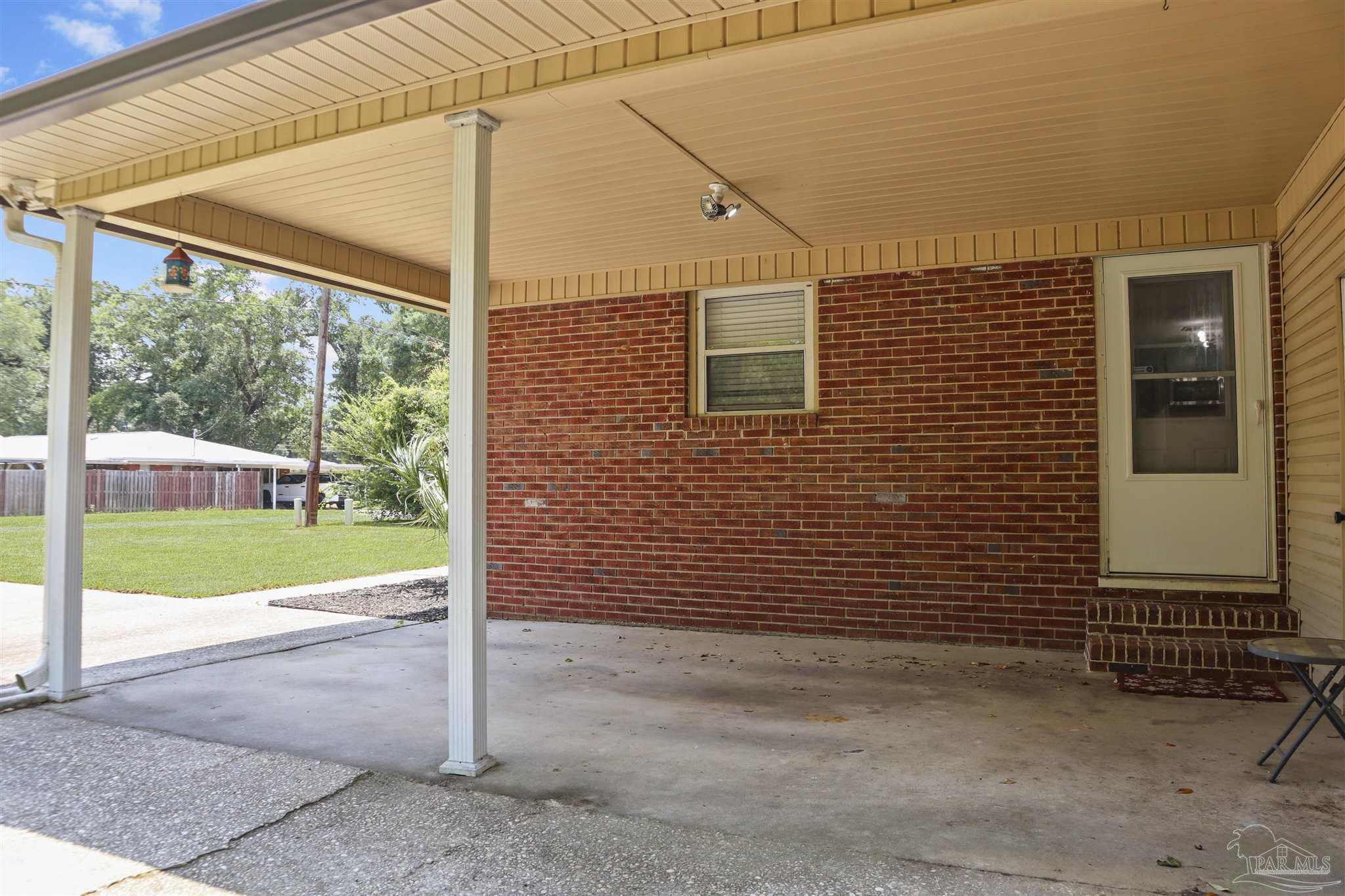 5925 Prince Road Pensacola, FL 32503 - Photo 45 of 51 a view of a backyard with a door and wooden fence