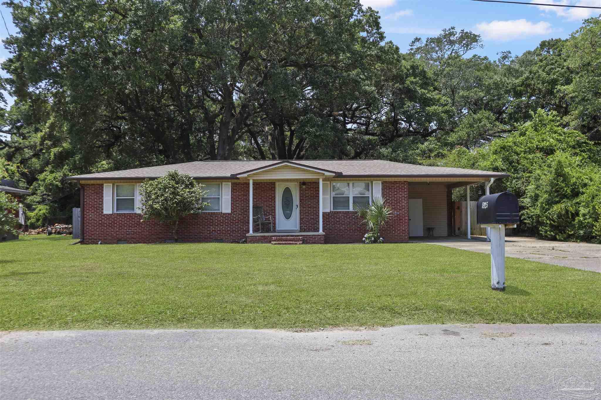 5925 Prince Road Pensacola, FL 32503 - Photo 48 of 51 a front view of a house with a yard and trees