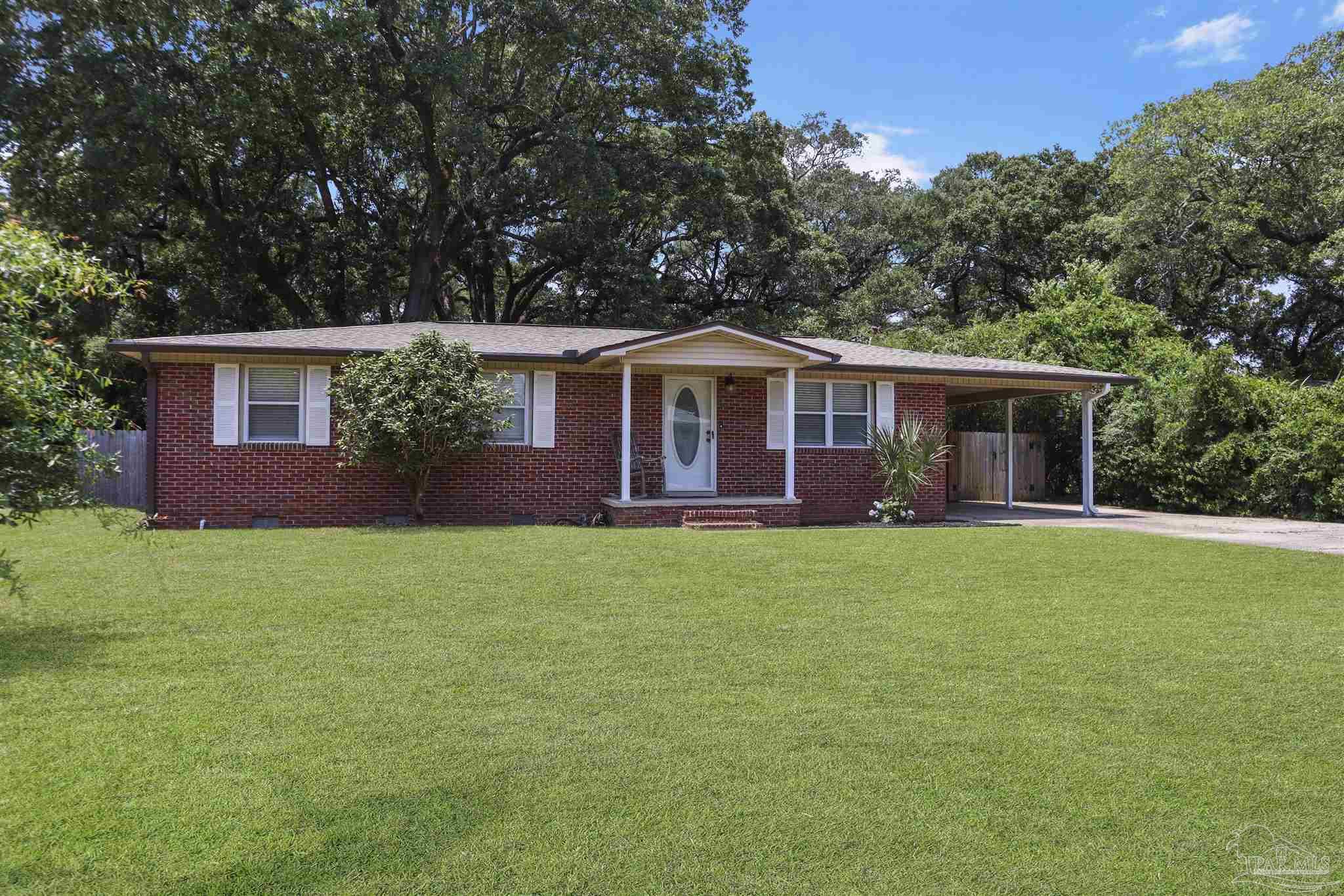 5925 Prince Road Pensacola, FL 32503 - Photo 49 of 51 a front view of a house with a garden