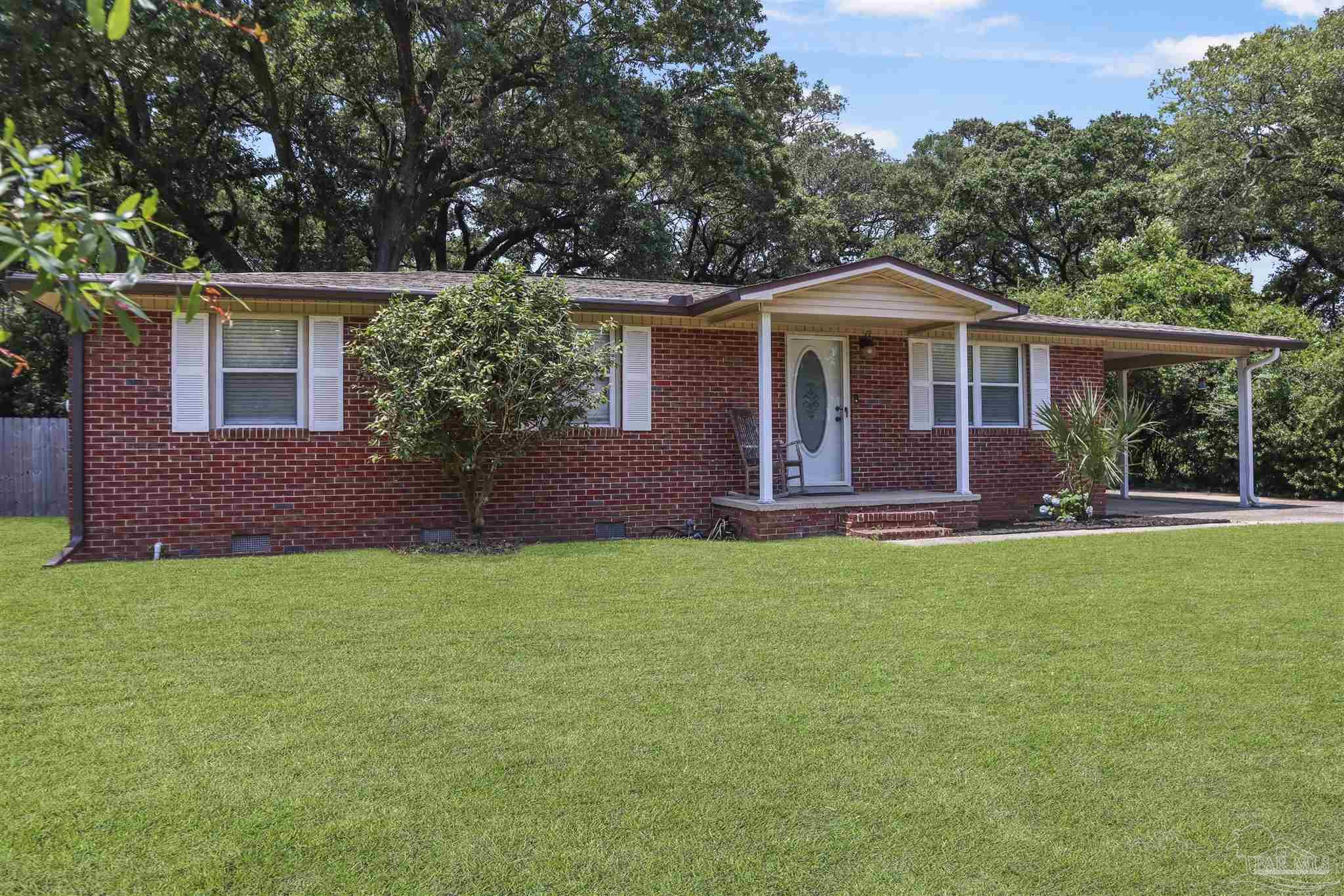 5925 Prince Road Pensacola, FL 32503 - Photo 50 of 51 a front view of a house with garden