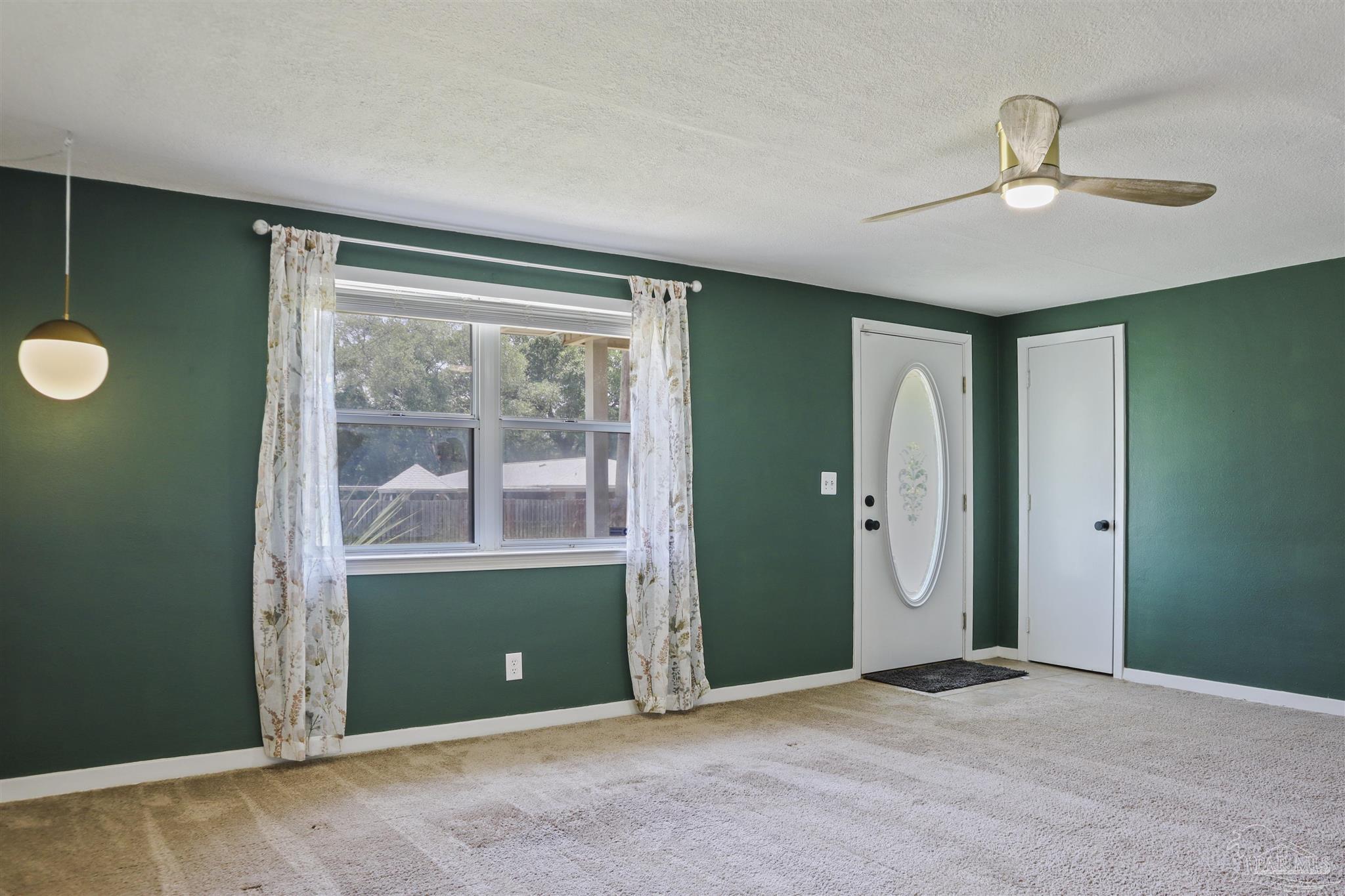 5925 Prince Road Pensacola, FL 32503 - Photo 5 of 51 an empty room with a window and a ceiling fan