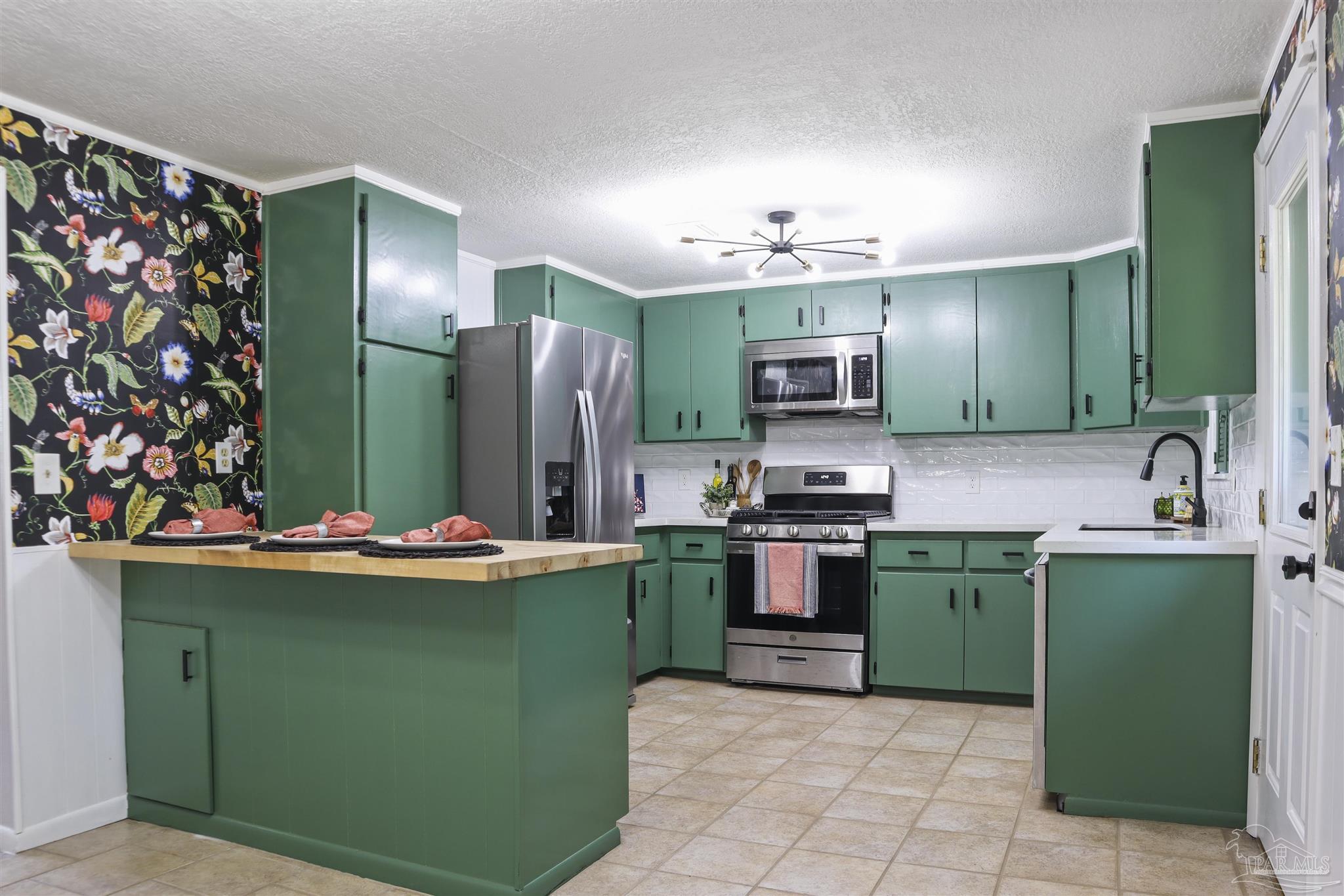 5925 Prince Road Pensacola, FL 32503 - Photo 6 of 51 a kitchen with sink cabinets and refrigerator