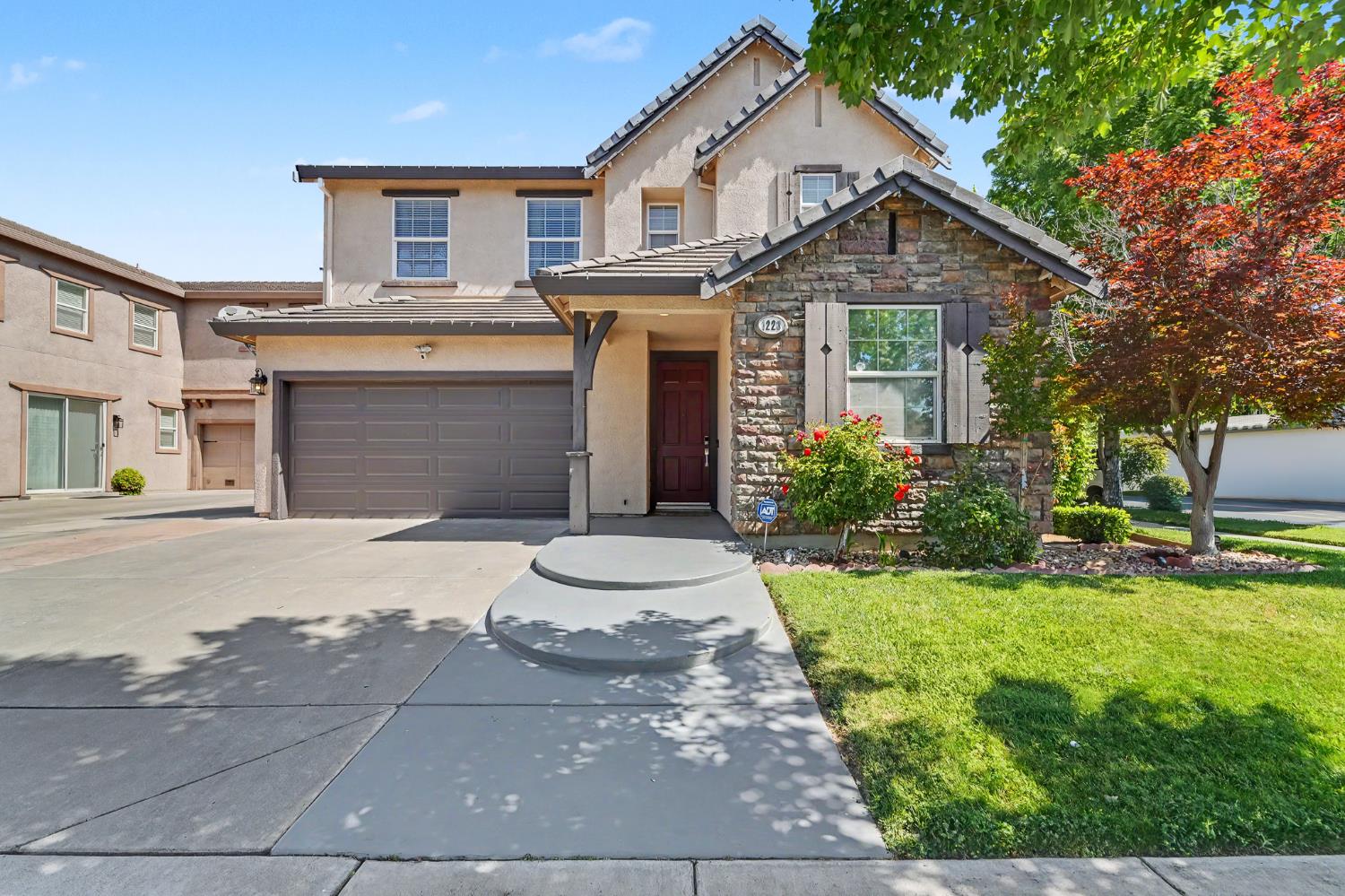a front view of a house with a yard and garage