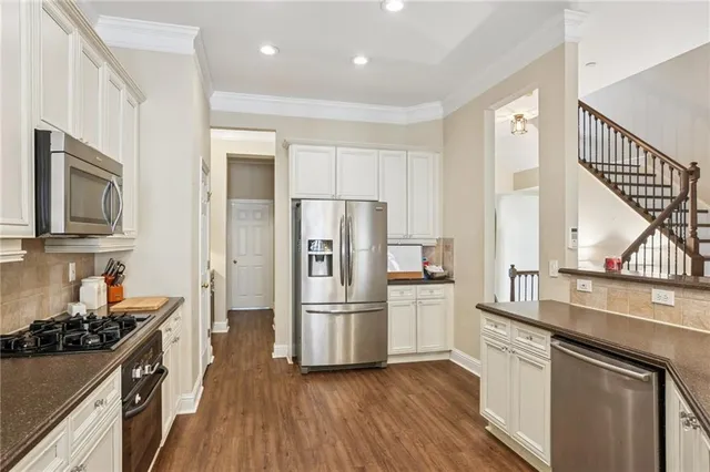 a kitchen with stainless steel appliances a refrigerator sink and stove