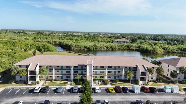 an aerial view of a house with car parked