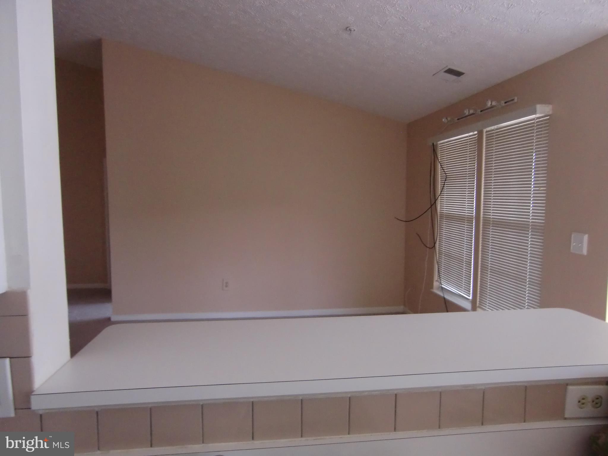 2445 Blue Spring Court, Unit 303 Odenton, MD 21113 - Photo 13 of 15 view from kitchen over breakfast bar to living roo