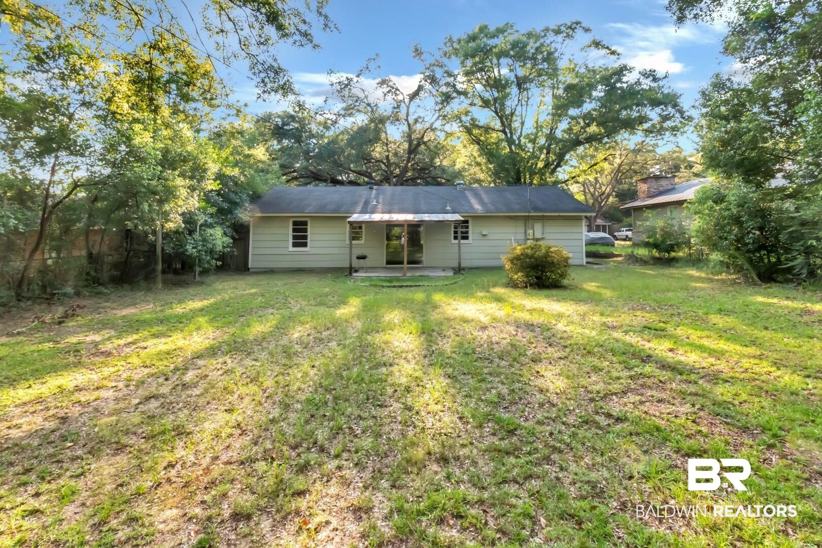 1220 Garland Drive Mobile, AL 36618 - Photo 22 of 25 Rear view of house with a lawn