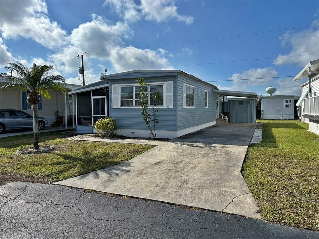 10101 Burnt Store Road, Unit 103 Punta Gorda, FL 33950 - Photo 1 of 1 a front view of a house with garden