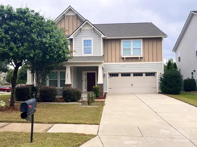 a front view of a house with garden