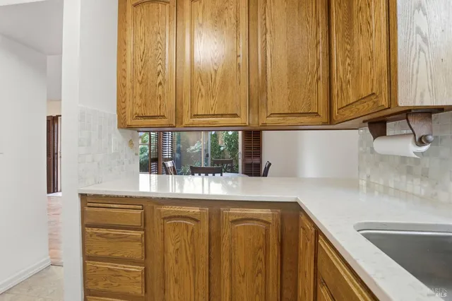 a kitchen with stainless steel appliances granite countertop a sink and a white cabinets