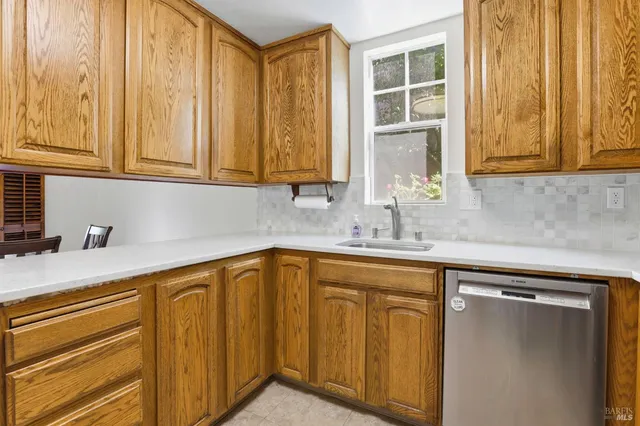a kitchen with stainless steel appliances granite countertop a sink and cabinets