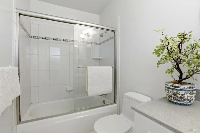 a bathroom with a shower a toilet and a shower