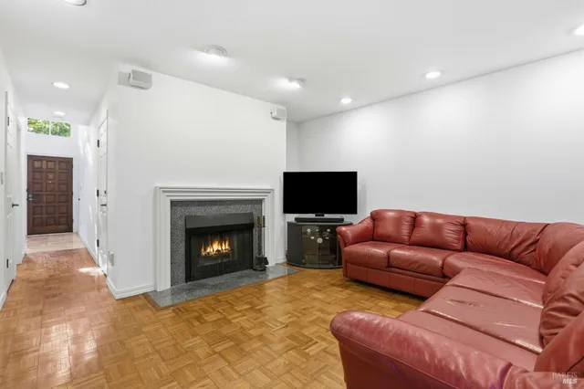 a living room with furniture a fireplace and a flat screen tv