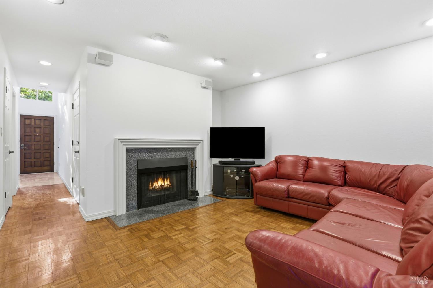 380 Sunset Way Mill Valley, CA 94941 - Photo 7 of 41 a living room with furniture a fireplace and a flat screen tv